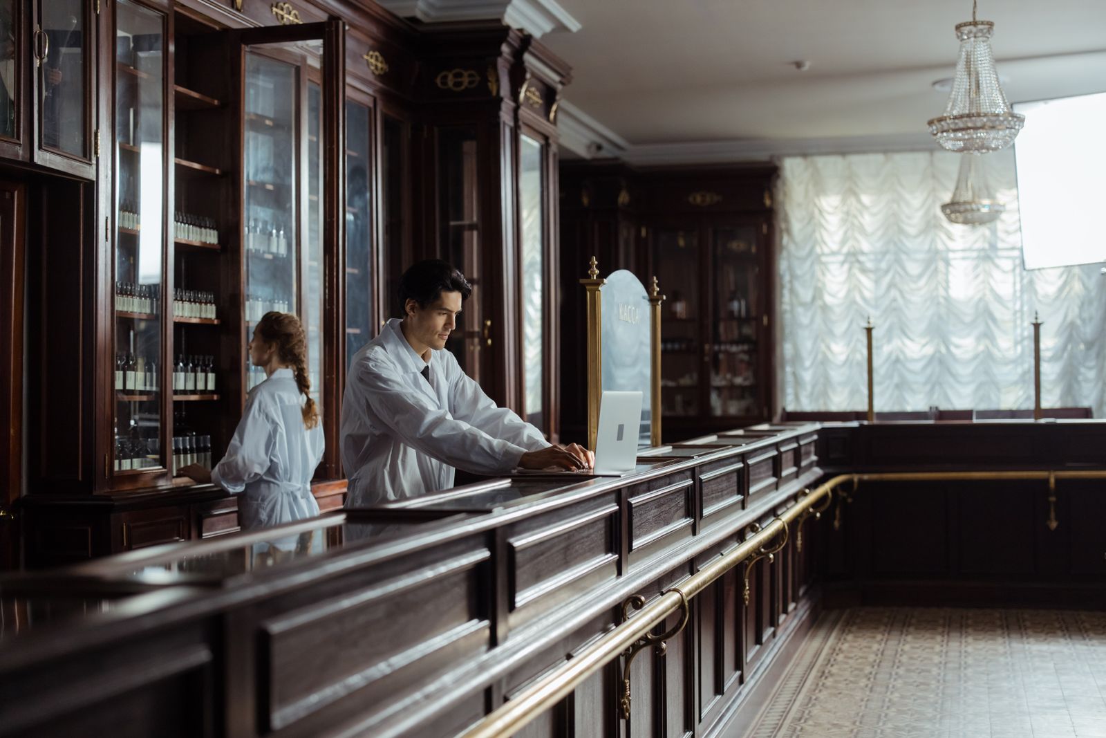 A pharmacist checking a prescription at the counter